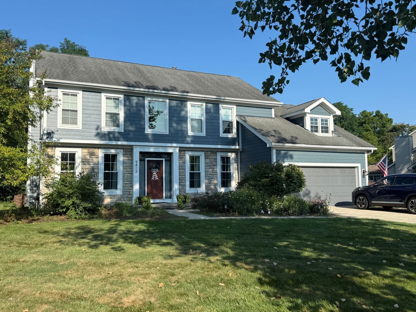 Corner view of the same Columbus-area home showing James Hardie lap siding and white trim