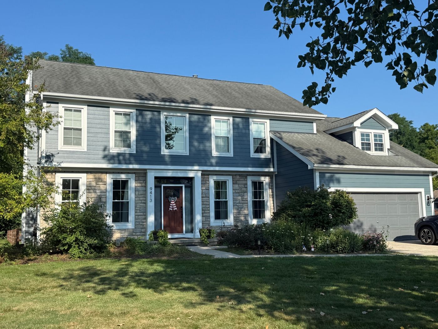 Two-storey home in the Columbus area with new James Hardie fiber cement siding in slate blue
